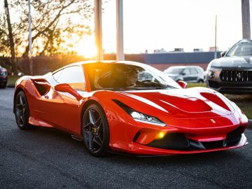 red ferrari 458 italia on road during daytime