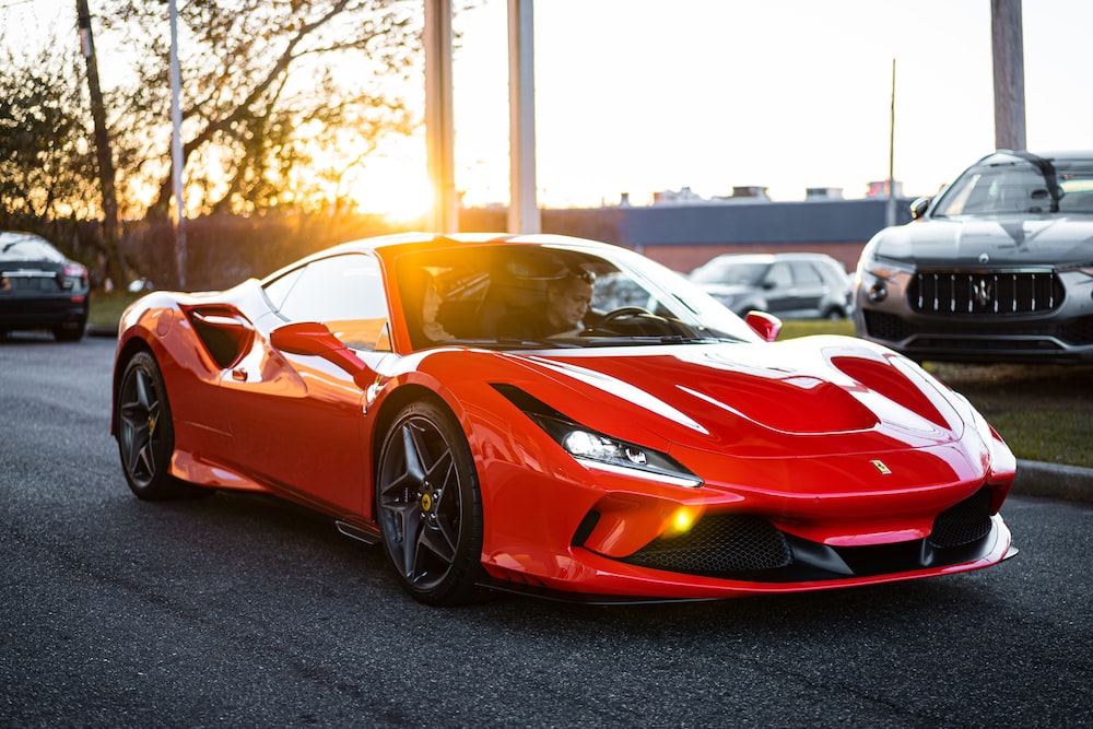 red ferrari 458 italia on road during daytime