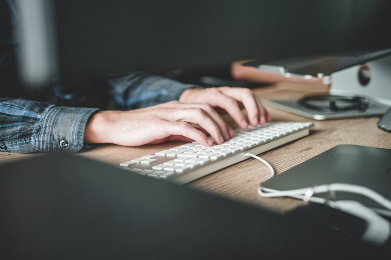 A woman types on her computer.